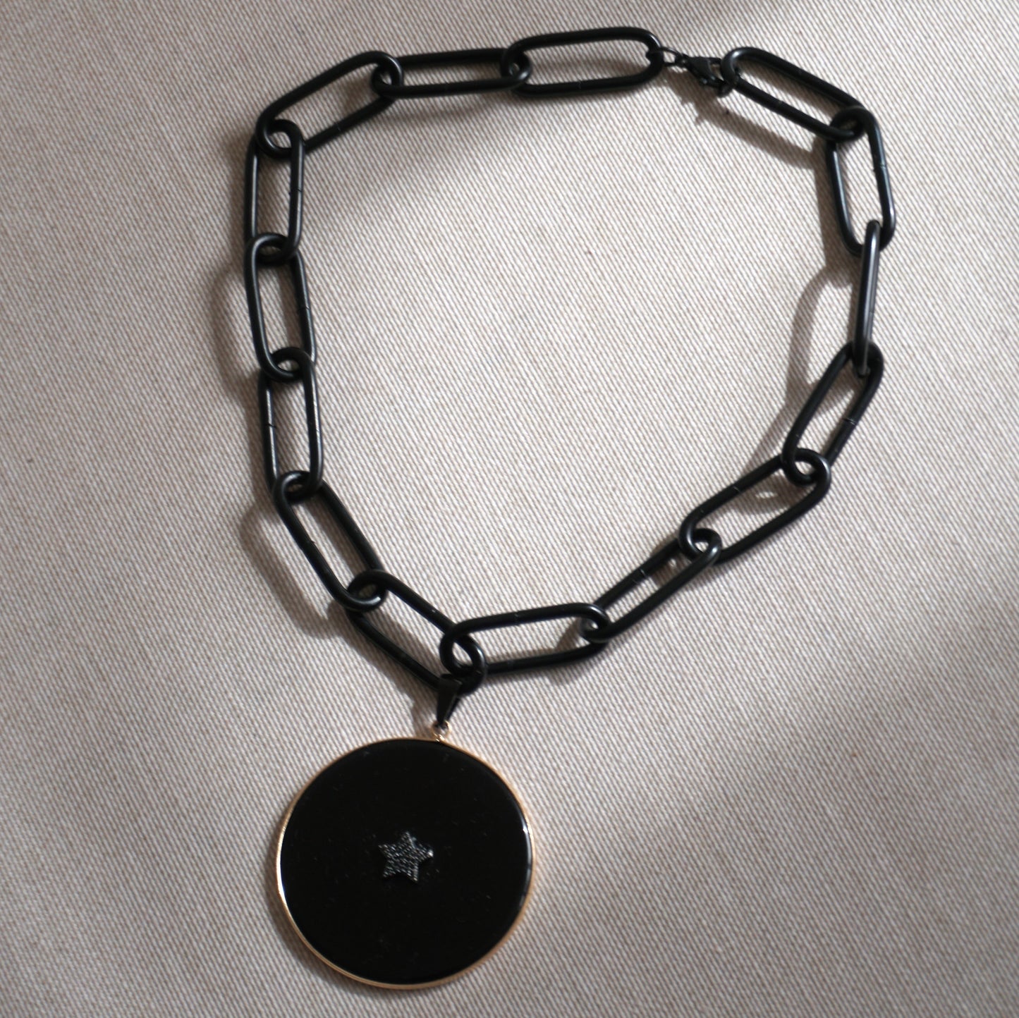 Catena nera a maglia grossa con cerchio in onice e stella in strass